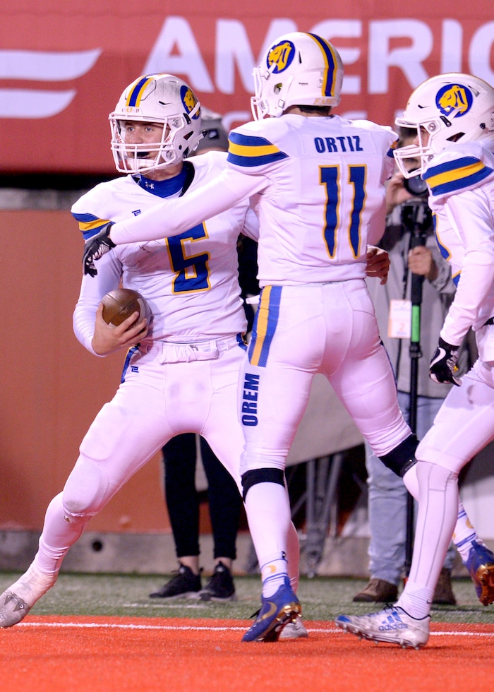 (Leah Hogsten  |  The Salt Lake Tribune)  Orem's quarterback Cooper Legas celebrates his touchdown with Jaxon Williams and Brayden Theurer.  Orem High School defeated Sky View High School 28-12 during their class 4A state semifinal game at Rice-Eccles Stadium, Friday, Nov. 10, 2017.