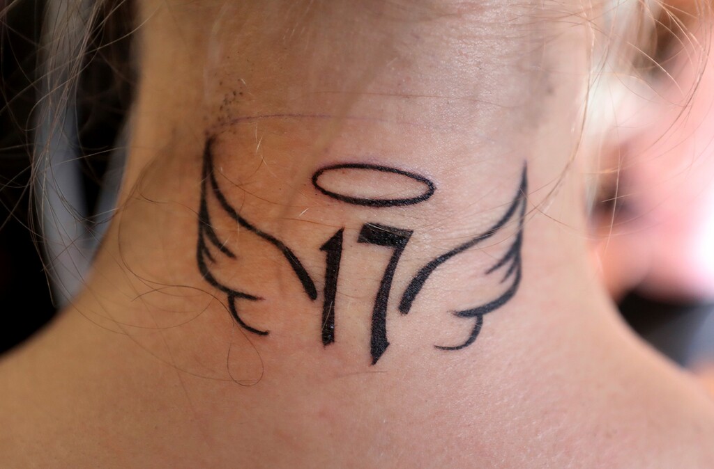 In this Sunday, March 11, 2018, photo, Rio Gonzales, 17, a Coral Springs High School student, shows a tattoo she got in Coral Springs, Fla., to honor the students who were killed in the mass shooting at Marjory Stoneman Douglas High School. Gonzales and hundreds of other members of the community participated in the donation-based fundraiser sponsored by No Hard Feelings Tattoo Gallery in Coral Springs. The tattoo shop, along with nine other tattoo artists and body piercers, offered a day of free tattoos to the community with donations going toward the families and victims of the Marjory Stoneman Douglas shooting. (Susan Stocker/South Florida Sun-Sentinel via AP)