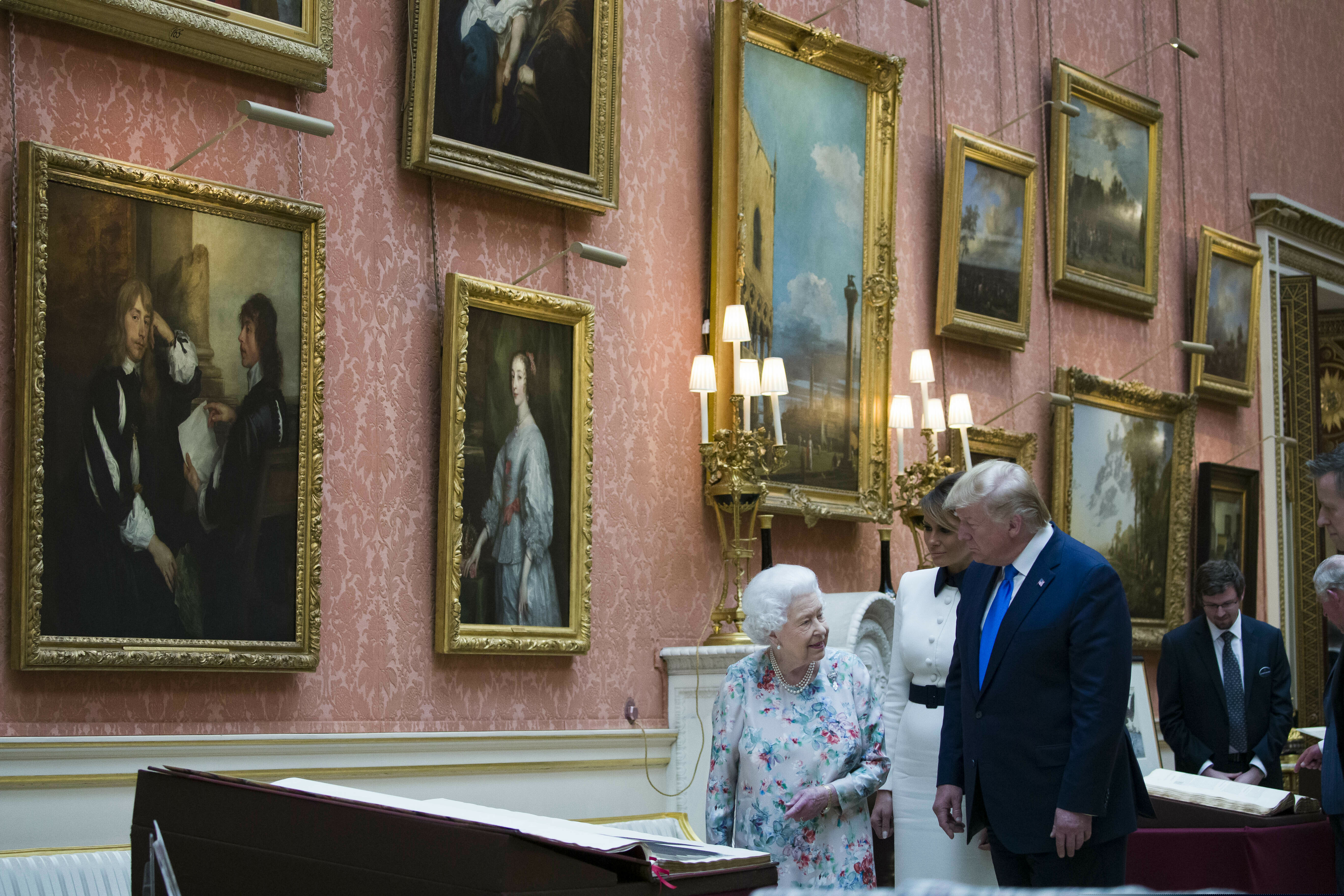 Queen Elizabeth II shows items in the Royal Gifts collection to first lady Melania Trump and President Donald Trump at Buckingham Palace, Monday, June 3, 2019, in London. (AP Photo/Alex Brandon)