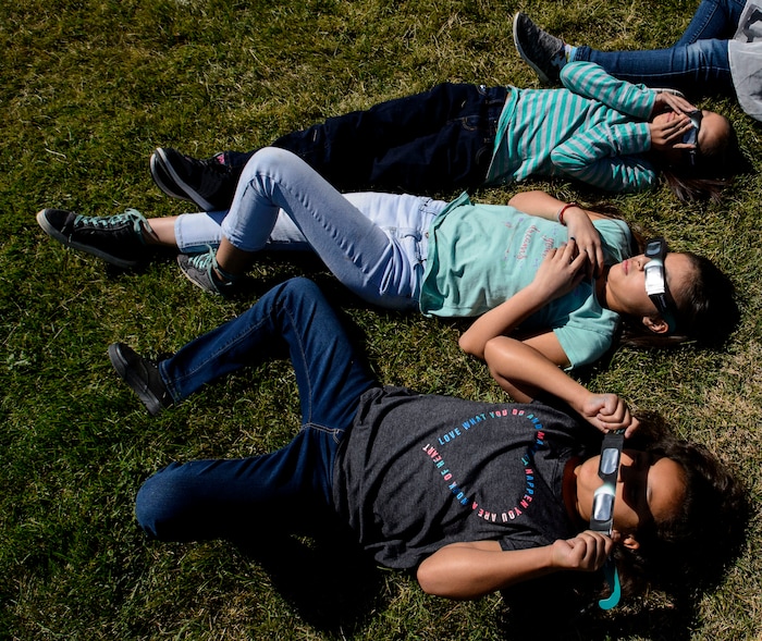 (Steve Griffin  |  The Salt Lake Tribune) Meadowlark Elementary School students watch The Great Eclipse during the Salt Lake School District's first day of the 2017-2018 school year. STEAM teacher-coordinator Wendi Laurence who formerly worked at NASA has been planning an event around the eclipse. All students had glasses to view the event and many had lunch outside at the Salt Lake City school Monday August 21, 2017.