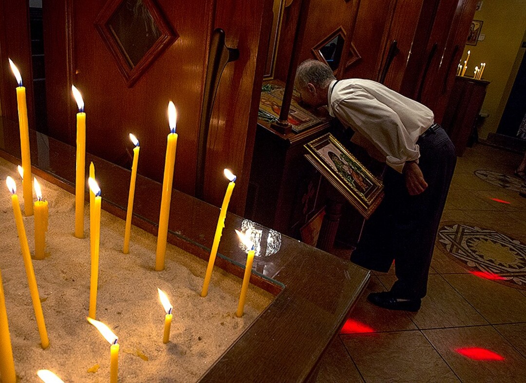 (Leah Hogsten  |  The Salt Lake Tribune) Dean Dinas kisses the Teotokos and Christ icon prior to leaving the Holy Trinity Cathedral Greek Orthodox Church during the 42nd Annual Greek Festival in Salt Lake City.