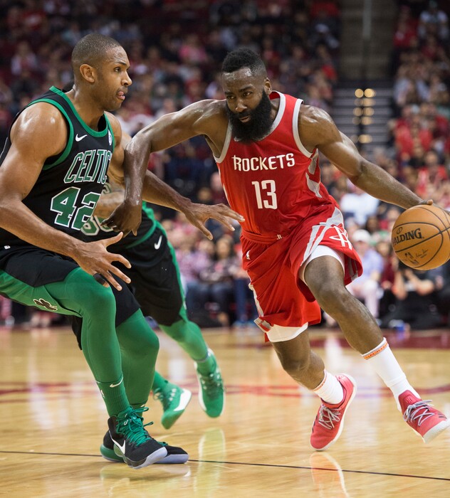 Houston Rockets guard James Harden (13) drives by Boston Celtics forward Al Horford (42) during the first half of an NBA basketball game Saturday, March 3, 2018, in Houston. (AP Photo/George Bridges)