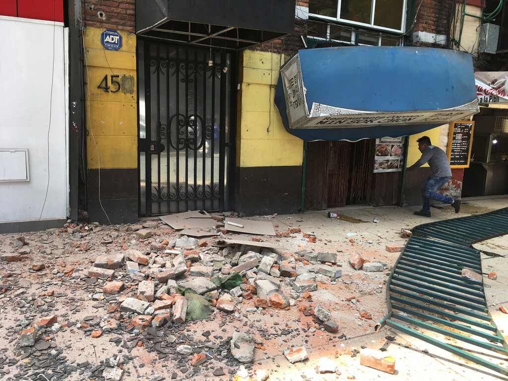 A man enters a damaged building after an earthquake in Mexico City, Tuesday, Sept. 19, 2017. A powerful earthquake has jolted Mexico, causing buildings to sway sickeningly in the capital on the anniversary of a 1985 quake that did major damage. (AP Photo/Eduardo Verdugo)