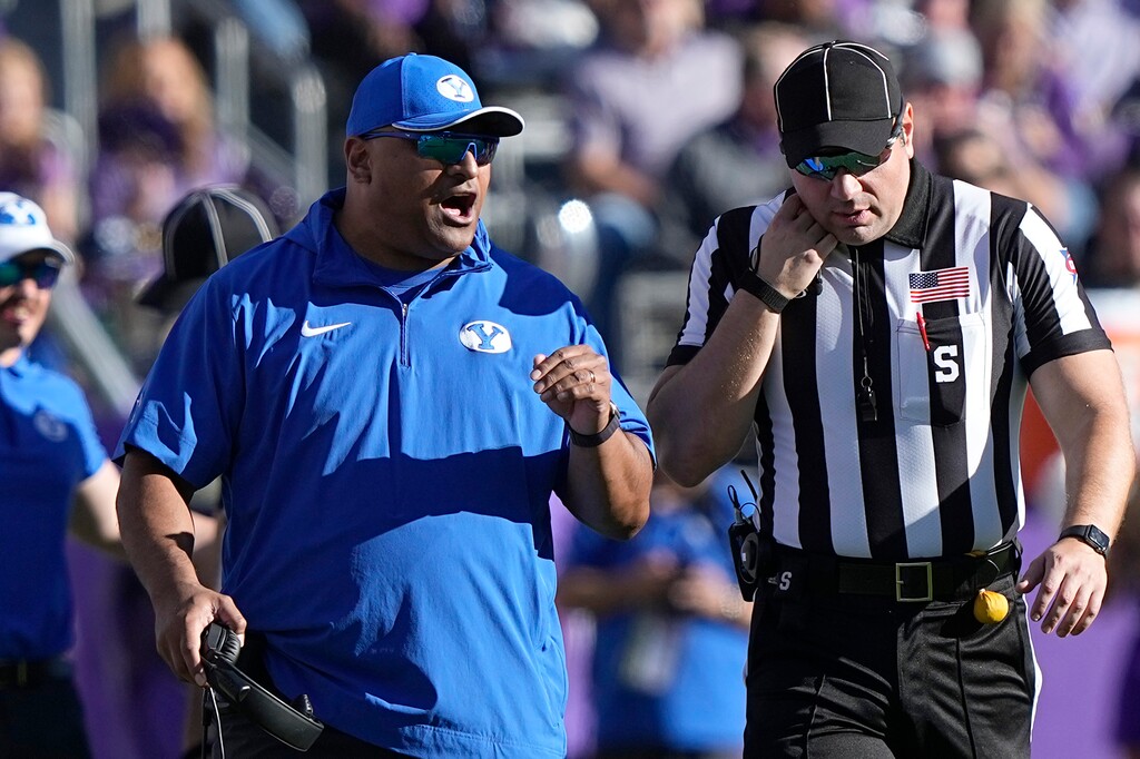 (LM Otero | AP) BYU head coach Kalani Sitake, left, yells at an official, right, during the second half of an NCAA college football game against TCU, Saturday, Oct. 14, 2023, in Fort Worth, Texas.