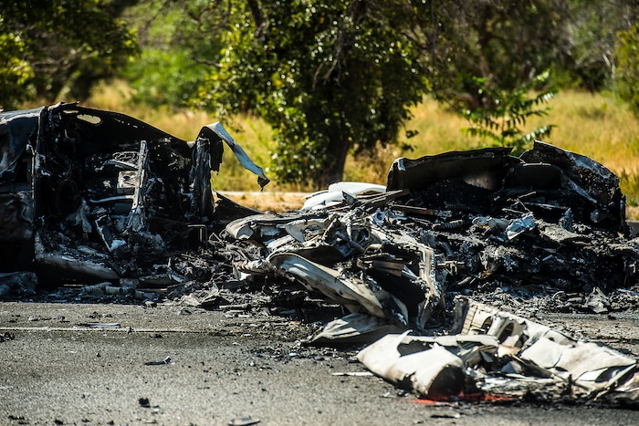 (Chris Detrick  |  The Salt Lake Tribune)  The scene of a plane crash at 1900 West and 4500 South  in Roy Tuesday, September 12, 2017. The pilot of a single-engine airplane survived a fiery crash on a street in Roy Tuesday afternoon, authorities said. Roy police Sgt. Matthew Gwynn said the pilot was transported to a hospital “out of precaution,” as was the driver of a car that the plane hit.