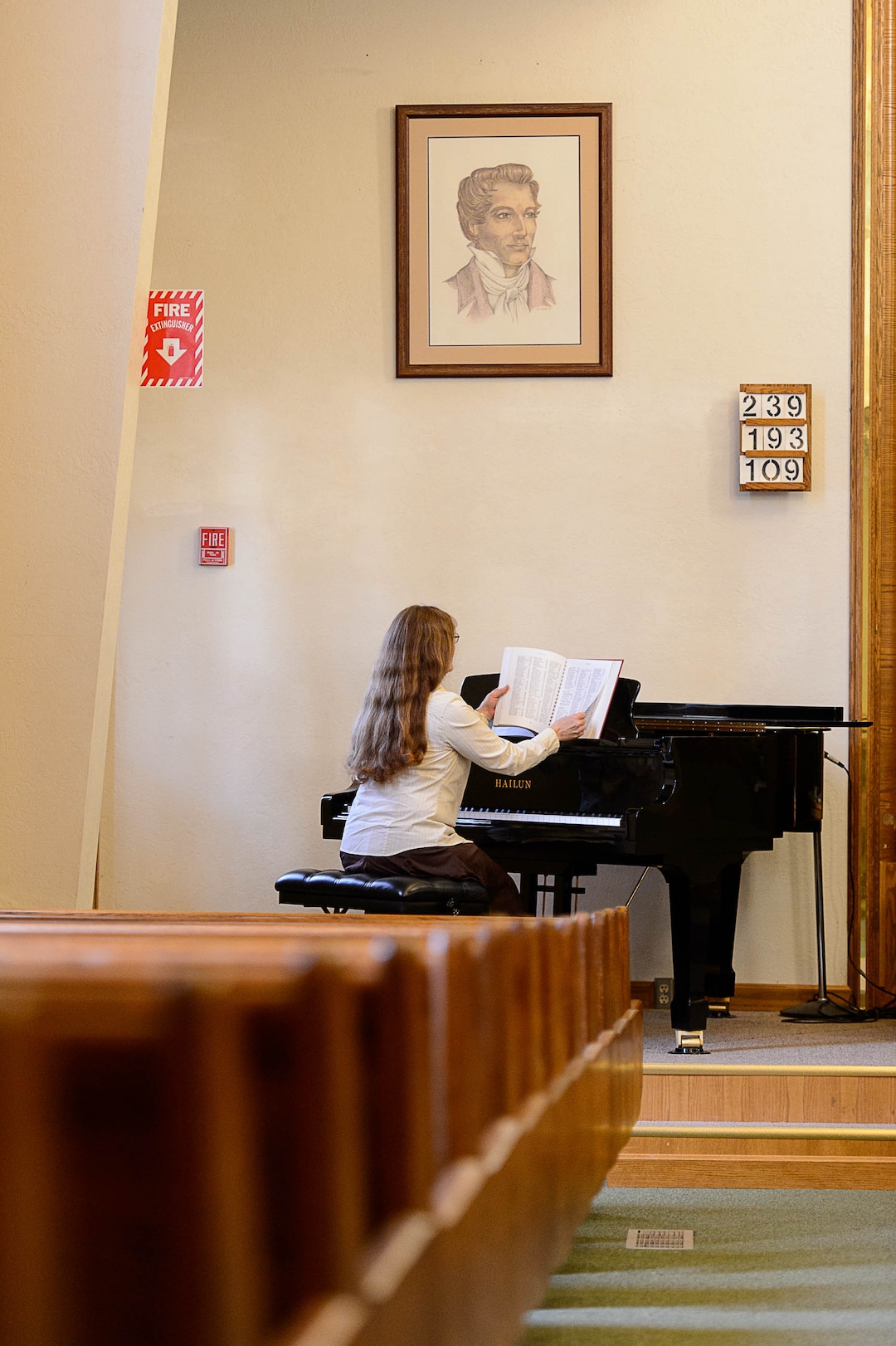 (Trent Nelson | The Salt Lake Tribune)  Gail Wissenbach prepares to play a hymn on the piano during a Sacrament Meeting of the Pinesdale Second Ward, in Pinesdale, Mont.