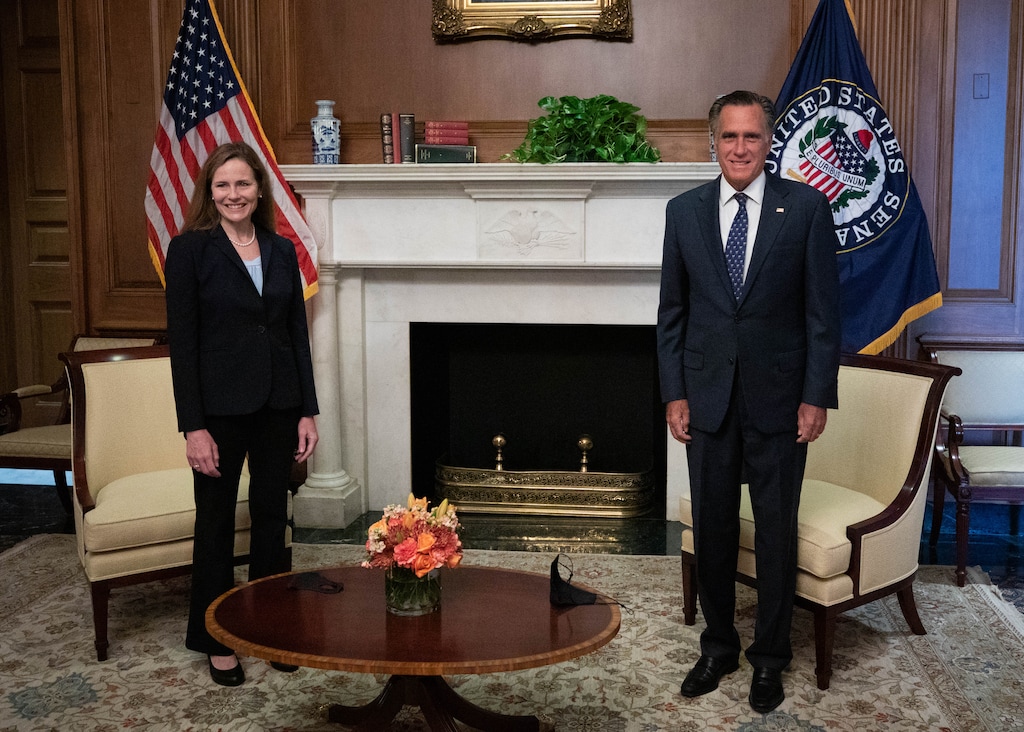 (Photo courtesy of Sen. Mitt Romney's office). Sen. Mitt Romney and Supreme Court nominee Amy Coney Barrett pose for photos before a meeting on Wednesday, Sept. 30, 2020.