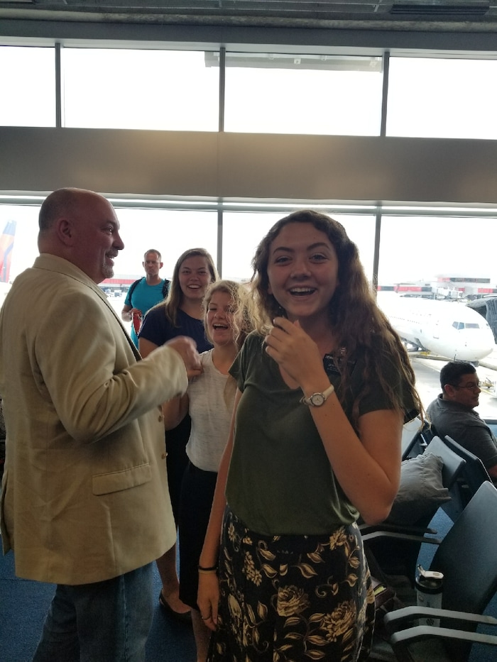Courtesy | Michael McDonald. Mormon missionary Erin McDonald meets by chance with her parents at the Atlanta airport while evacuating from Puerto Rico on September 23, 2017.