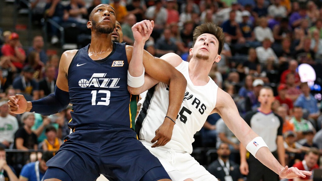 Utah Jazz's Tony Bradley (13) battles under the boards with San Antonio Spurs center Drew Eubanks (25) during the first half of an NBA summer league basketball game Monday, July 2, 2018, in Salt Lake City. (AP Photo/Rick Bowmer)