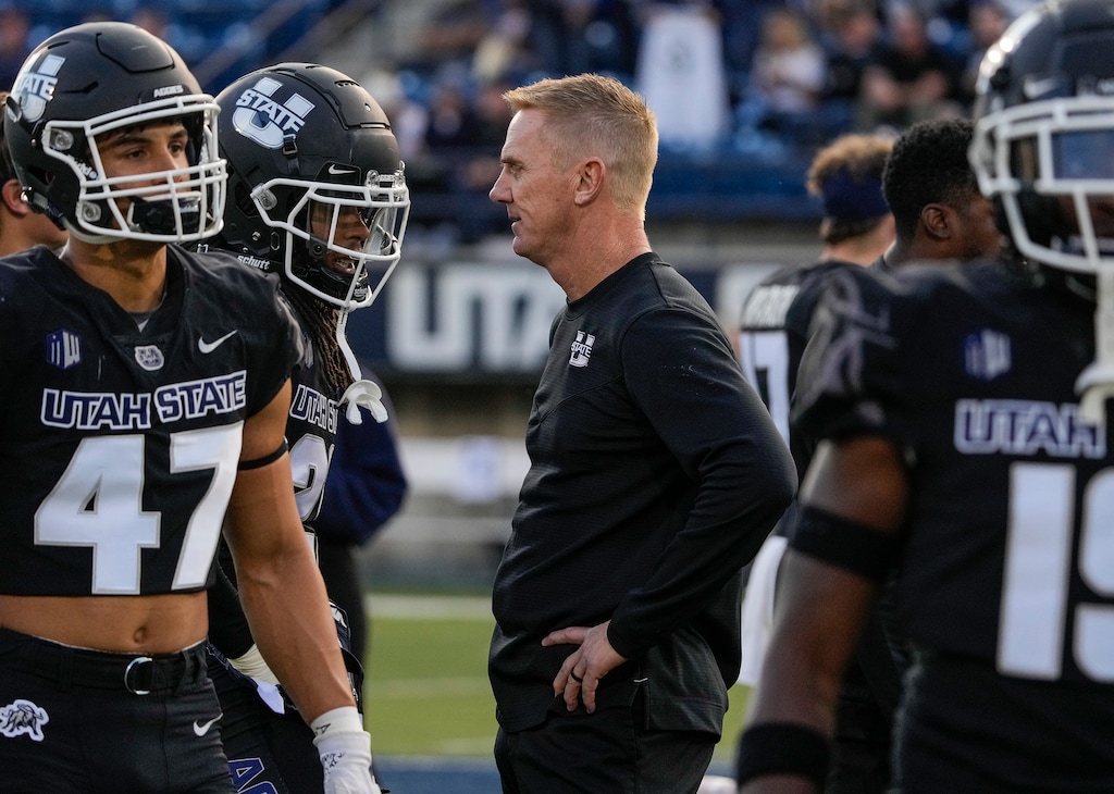 (Leah Hogsten | The Salt Lake Tribune) Utah State Aggies head coach Blake Anderson talks with his players as the Utah State Aggies host Brigham Young University Cougars at Maverik Stadium Oct. 1, 2021.