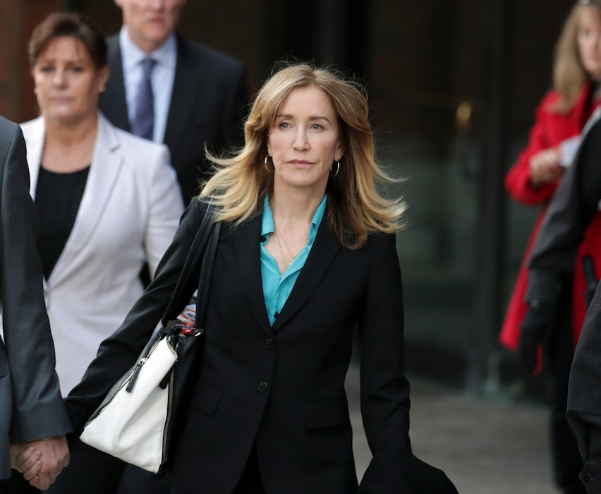(Charles Krupa | AP file photo) This April 3, 2019 file photo shows actress Felicity Huffman departing federal court in Boston after facing charges in a nationwide college admissions bribery scandal. On Sept. 13, she was sentenced to 14 days in prison.