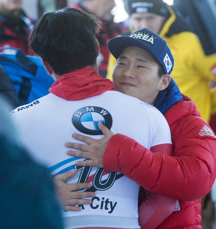 (Rick Egan  |  The Salt Lake Tribune)   Sungbin Yun gets a hug at the fishline after his first place finish in the BMW IBSF World Cup Men's Skeleton competition, Saturday, November 18, 2017.