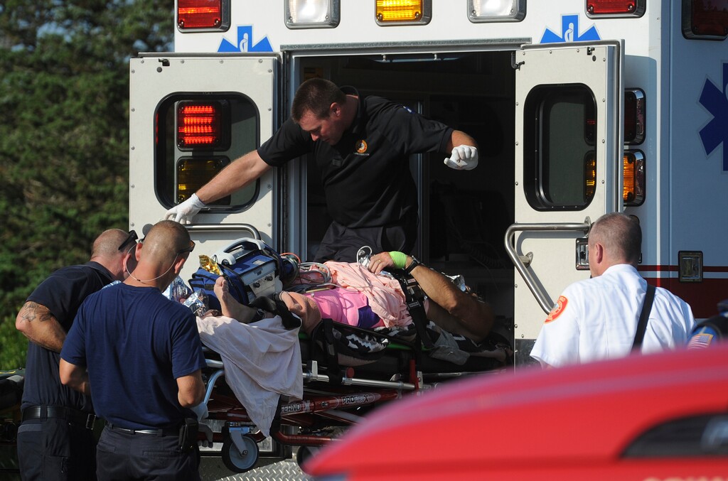 A man is transferred from a Truro ambulance to a MedFlight helicopter after being attacked by a shark, Wednesday, Aug. 15, 2018 in South Wellfleet, Mass. A man swimming off Cape Cod was attacked by a shark on Wednesday and was airlifted to a hospital. It was the first shark attack on a human on the popular summer tourist destination since 2012. (Merrily Cassidy