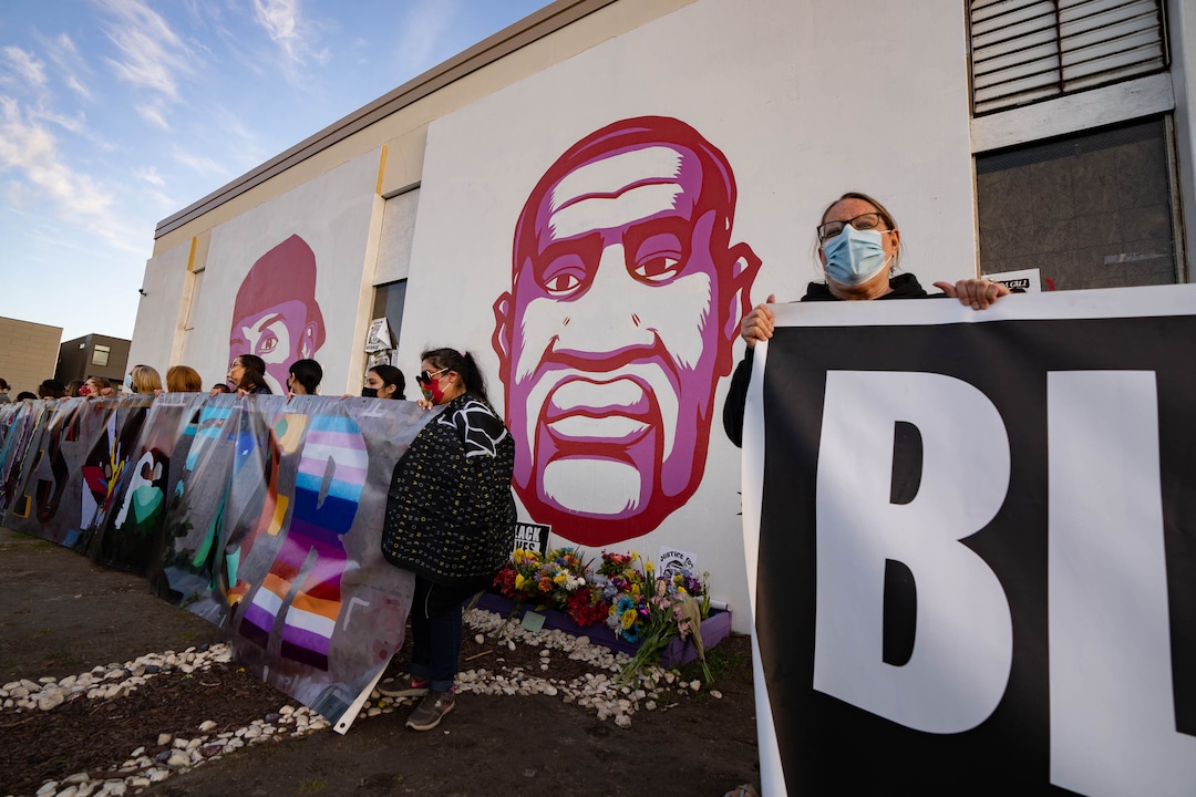 (Francisco Kjolseth  | The Salt Lake Tribune) People gather at the murals of people killed by police in Salt Lake City on Tuesday, April 20, 2021, following the guilty verdict on all three counts in the murder trial of former Minneapolis police Officer Derek Chauvin in the death of George Floyd.