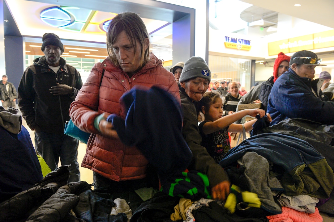 Leah Hogsten  |  The Salt Lake Tribune Crystal Baker, left, thumbs through shoes and clothing at the Utah Jazz and the Larry H. Miller Group sponsored annual “We Care – We Share” benefit, Monday, Nov 19, 2018.