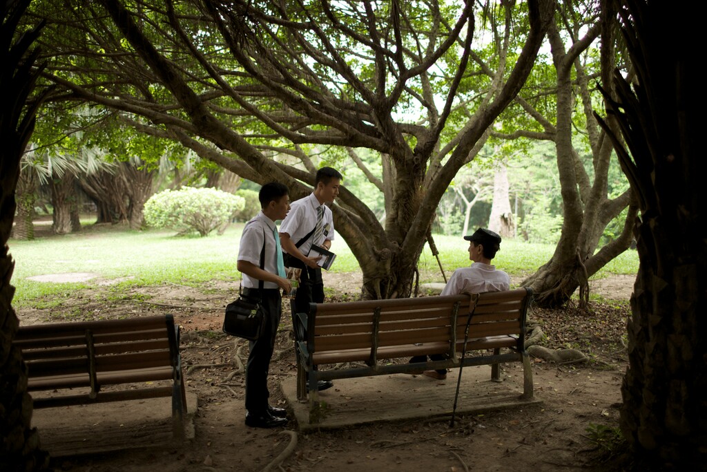 (The Church of Jesus Christ of Latter-day Saints) Latter-day Saint missionaries talk to a man in a park in Taiwan.