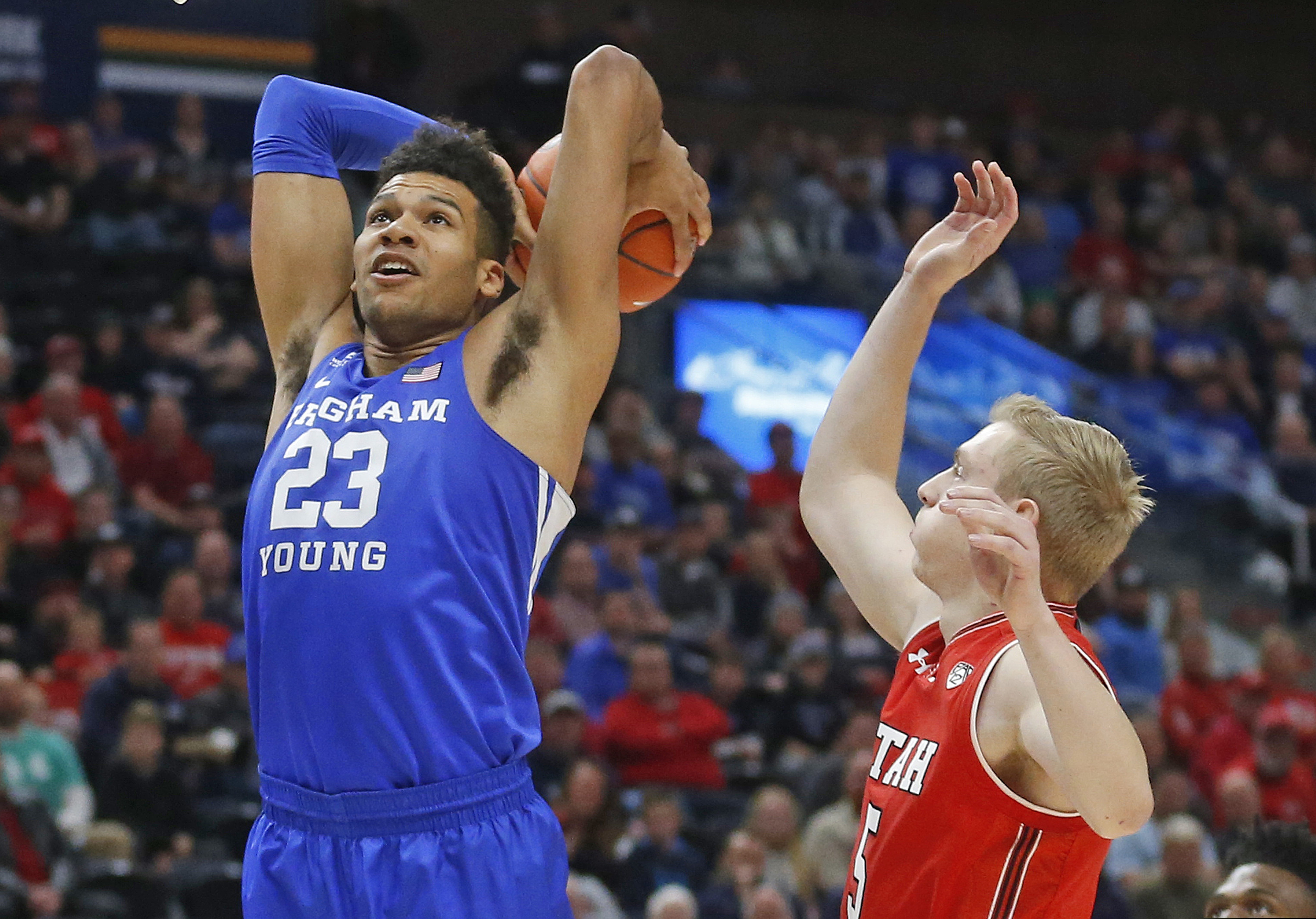 BYU forward Yoeli Childs (23) dunks on Utah guard Parker Van Dyke (5) in the first half during an NCAA college basketball game Saturday Dec. 8, 2018, in Salt Lake City. Childs announced Wednesday that he is turning professional and leaving BYU with one season of eligibility remaining. (AP Photo/Rick Bowmer)