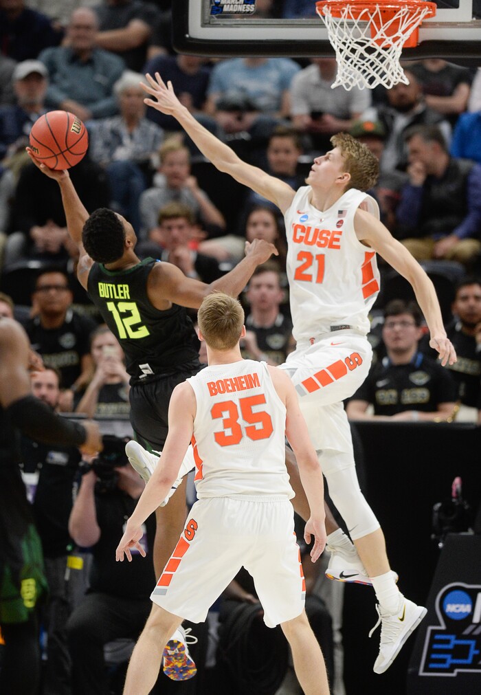 (Francisco Kjolseth  |  The Salt Lake Tribune)  Baylor Bears guard Jared Butler (12) puts in a difficult shot past Syracuse Orange forward Marek Dolezaj (21) as Syracuse faces Baylor in their first round menÕs NCAA March Madness tournament game at Vivint Smart Home Arena in Salt Lake City on Thursday, March 21, 2019.
