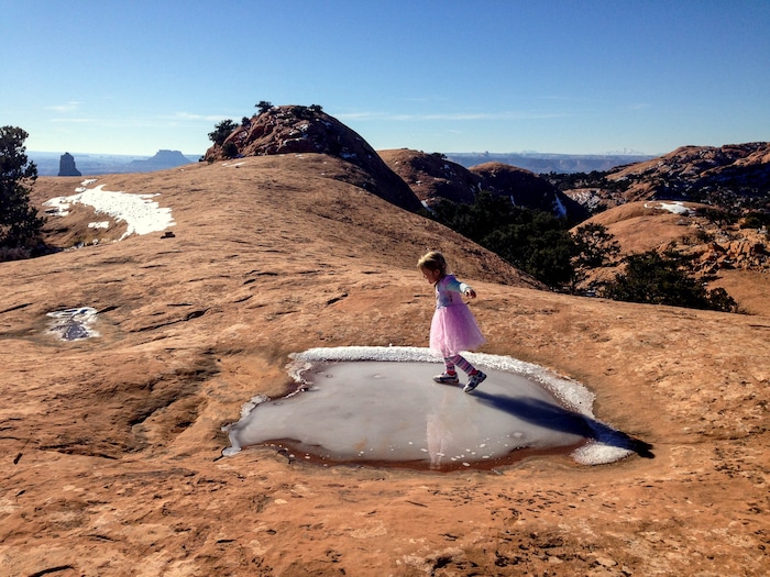 Erin Alberty  |  The Salt Lake TribuneThe author's daughter glides on an icy pothole Dec. 2, 2015 on Whale Rock in Canyonlands National Park. 