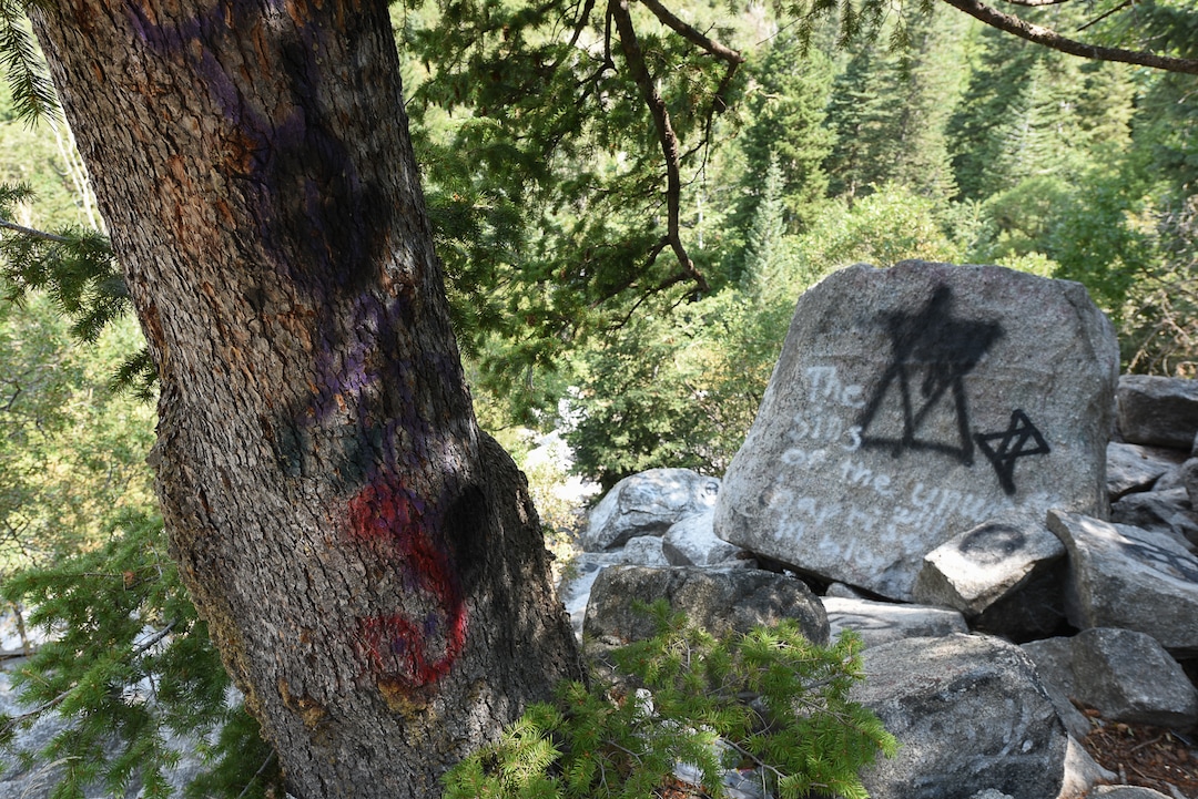 (Francisco Kjolseth  |  The Salt Lake Tribune)  Graffiti has proliferated in lower Little Cottonwood Canyon, where vandals, often wielding cans of fluorescent-colored spray paint, have covered granite faces, trees and structures. The vandalism is particularly apparent along the Temple Quarry Trail and the creek at the Moon Rock swimming hole and former pavilion site. Volunteers using donated equipment and solvents spend thousands of hours removing the paint from the rocks only to see graffiti return to the same faces or on rock nearby.