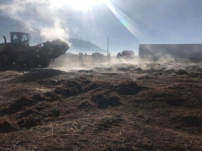 (Photo courtesy of the Juab County Fire District) Juab County Fire District crews use a dozer to pull apart a smoldering compost pile at the Young Living Lavender Farm in Mona. Fire personnel responded to the farm Sunday morning, and on Monday afternoon said they still had a good amount of work to do. Crews are pulling the compost pile apart and knocking the flames down with water.