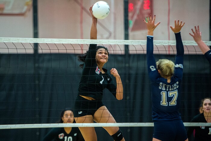 (Chris Detrick | The Salt Lake Tribune) West's Dana Manu (7) spikes the ball past Skyline's Kiana Crawford (17) during the volleyball match at West High School Tuesday, October 3, 2017.