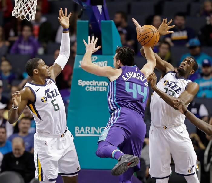 Charlotte Hornets' Frank Kaminsky (44) is fouled as he drives between Utah Jazz's Joe Johnson (6) and Royce O'Neale (23) during the first half of an NBA basketball game in Charlotte, N.C., Friday, Jan. 12, 2018. (AP Photo/Chuck Burton)