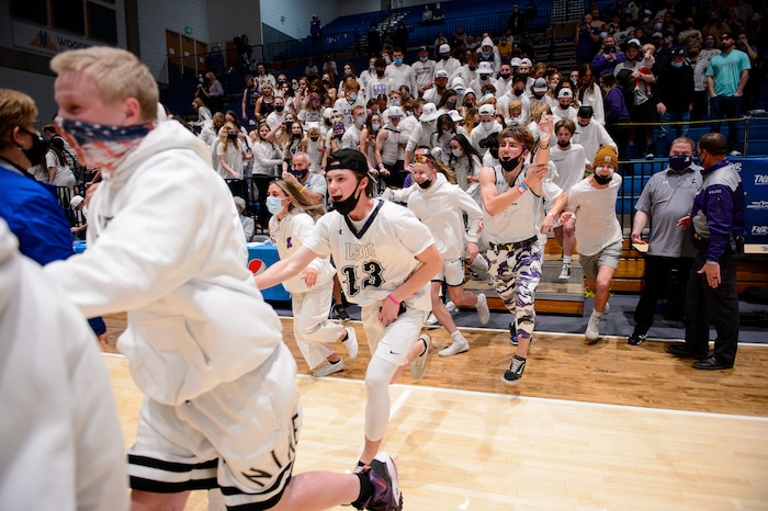 (Trent Nelson | The Salt Lake Tribune) Lehi fans rush the court to celebrate a win over Farmington High School in the 5A boys basketball state championship game, in Taylorsville on Saturday, March 6, 2021.