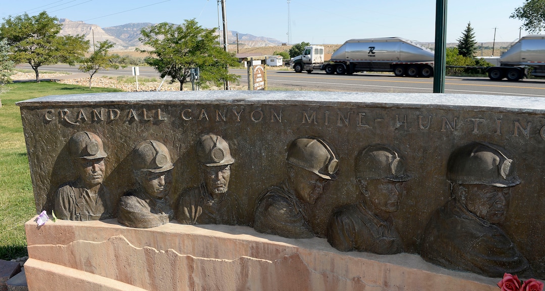(Al Hartmann  |  The Salt Lake Tribune)  A coal truck heads up Huntington Canyon, rolling past a memorial to the nine men who died in 2007's Crandall Canyon Mine disaster.