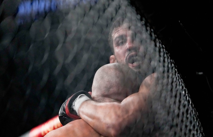 (Francisco Kjolseth | The Salt Lake Tribune) Leonardo Santos of Brazil gets pinned against the fence by Jared Gordon of the United States during their lightweight bout of UFC 278 at Vivint Arena on Saturday, Aug. 20, 2022. 