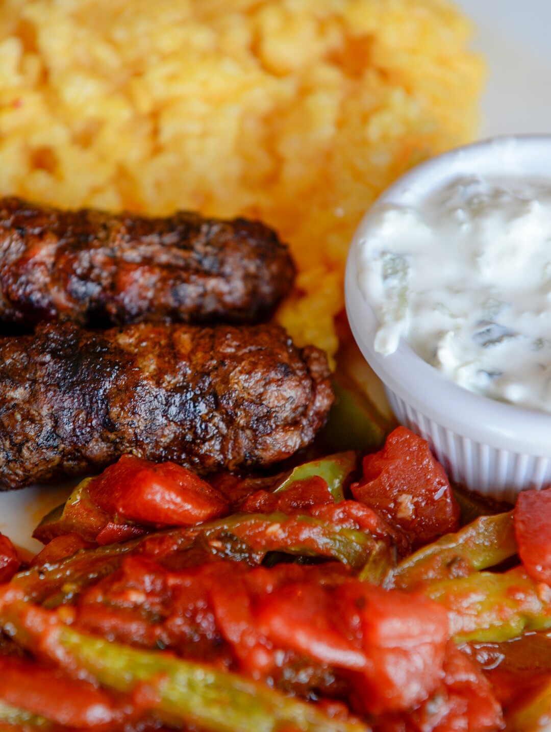 (Leah Hogsten  |  The Salt Lake Tribune) Lamb kebob made with two kebob skewers served with tomatoes and bell peppers, rice at Pasha Middle Eastern Cuisine, $16. Pasha Middle Eastern Cuisine specializes in a fusion of Moroccan, Mediteranean and Middle Eastern dishes, Aug. 14, 2019.