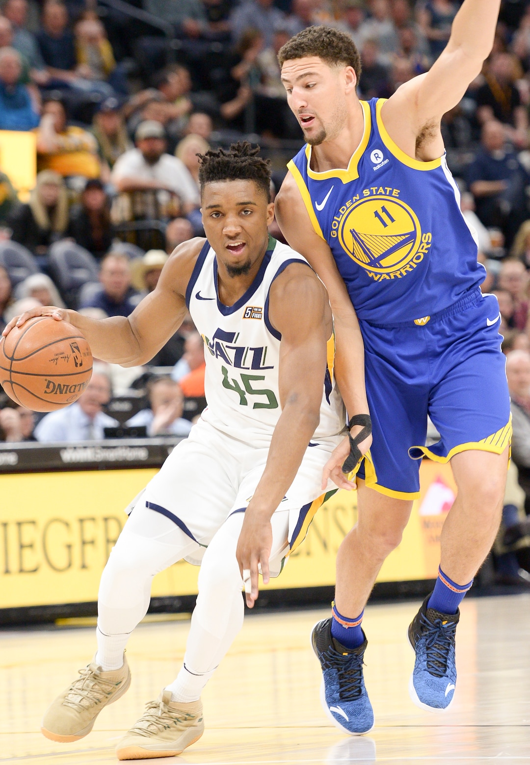 (Leah Hogsten  |  The Salt Lake Tribune)  Golden State Warriors guard Klay Thompson (11) pressures Utah Jazz guard Donovan Mitchell (45).  The Utah Jazz lead the Golden State Warriors 62-33 during their game, Tuesday, April 10, 2018 at the Vivant Smart Home Arena. 