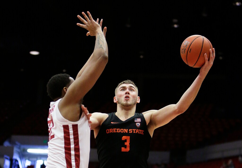 (Young Kwak | AP File) In this March 9, 2019, file photo, Oregon State forward Tres Tinkle (3) shoots next to Washington State forward Davante Cooper during the second half of an NCAA college basketball game in Pullman, Wash.