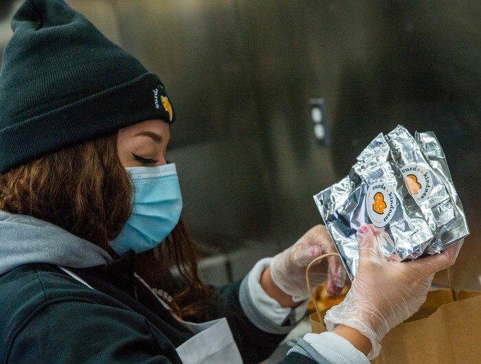 (Rick Egan | The Salt Lake Tribune)  Lissette Torres bags grilled cheese sandwiches for 600 health care workers as part of the the Curds + Kindness program, which supports local dairy farmers, at the South Jordan Health Center in Daybreak on Tuesday, Dec. 1, 2020.