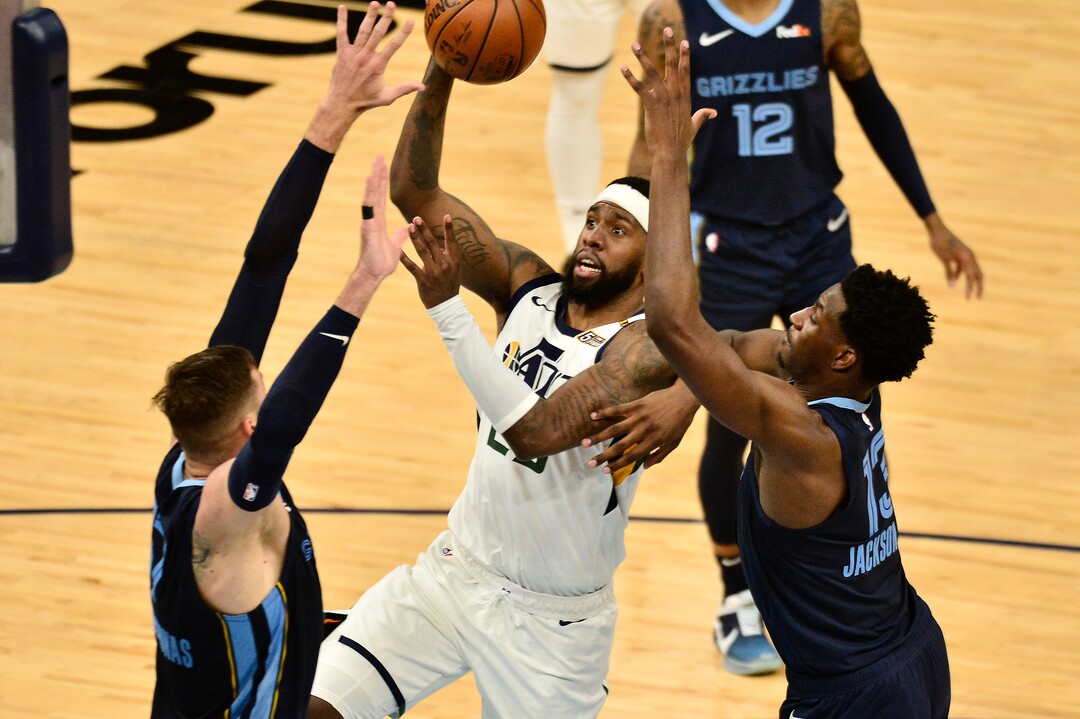 Utah Jazz forward Royce O'Neale (23) shoots between Memphis Grizzlies center Jonas Valanciunas (17) and forward Jaren Jackson Jr. (13) in the second half of Game 4 of an NBA basketball first-round playoff series Monday, May 31, 2021, in Memphis, Tenn. (AP Photo/Brandon Dill)