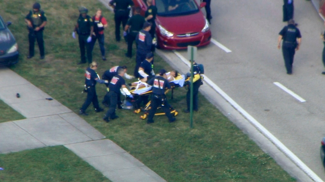 In this frame grab from video provided by WPLG-TV, emergency personnel wheel an injured person from the Marjory Stoneman Douglas High School in Parkland, Fla., following a shooting there on Wednesday, Feb. 14, 2018. (WPLG-TV via AP)