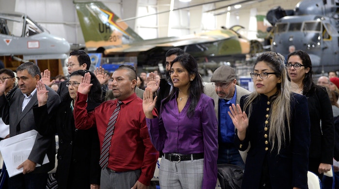 (Al Hartmann  |  The Salt Lake Tribune) 	
Thirty-five people from 24 countries raise their hand and take the oath of  allegiance to the United States in a naturalization ceremony by the U.S.  Citizenship and Immigration Service Tuesday Nov. 21 at the Hill Air Force Base Aerospace Museum.