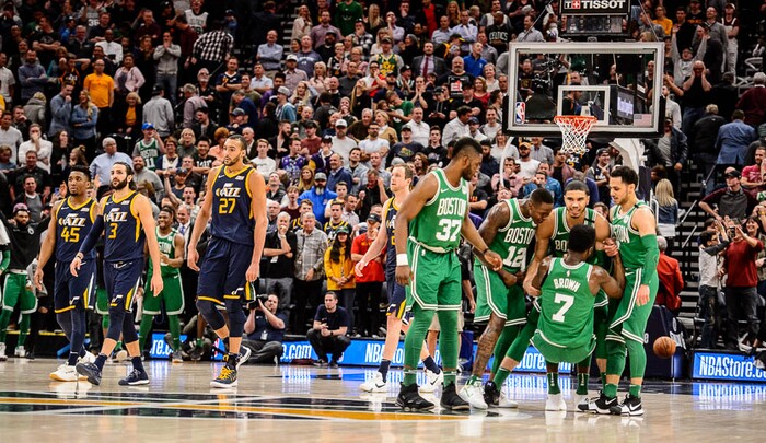 (Trent Nelson | The Salt Lake Tribune)  
Utah Jazz vs. Boston Celtics, NBA basketball in Salt Lake City, Wednesday March 28, 2018. Utah Jazz guard Donovan Mitchell (45), Utah Jazz guard Ricky Rubio (3) and Utah Jazz center Rudy Gobert (27) walk off the court while Boston players celebrate a three-pointer with .3 seconds remaining by Boston Celtics guard Jaylen Brown (7).