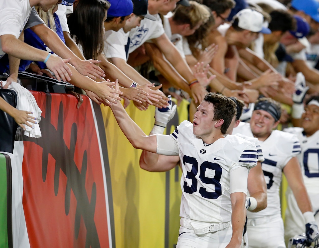 BYU place kicker Jake Oldroyd (39) celebrates with fans after an NCAA college football game against Arizona, Saturday, Sept. 3, 2016, in Phoenix. BYU defeated Arizona 18-16. (AP Photo/Rick Scuteri)