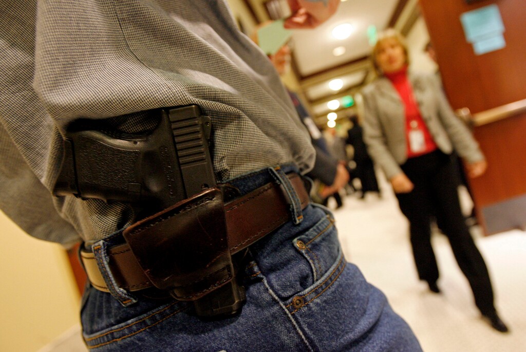 (Francisco Kjosleth | Tribune File Photo) This 2007 file photo shows a gun-rights activist openly carrying a gun at the state Capitol. Lawmakers in the coming session are expected once again to take up a proposal to do away with the requirement for a permit to carry a concealed weapon.