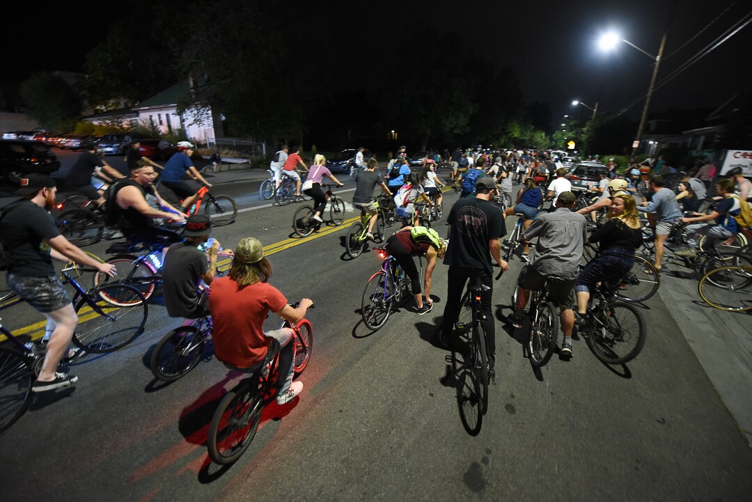 (Francisco Kjolseth  |  The Salt Lake Tribune)  A large group of cyclist begins their ride from the corner of 9th and 9th after gathering after 9pm in Salt Lake City on Thursday, July 26, 2018, for the weekly ride that has become known as the 999 Ride. The inclusive, all-welcoming slow casual social ride happens year round on Thursday nights, with riders often pedaling into the early morning hours. Newly released video shows rider Cameron Hooyer being struck and killed by a FrontRunner train at a downtown railroad crossing during last weeks ride when the 22-year-old failed to stop or heed the warning signals before crossing the tracks during the group ride. 