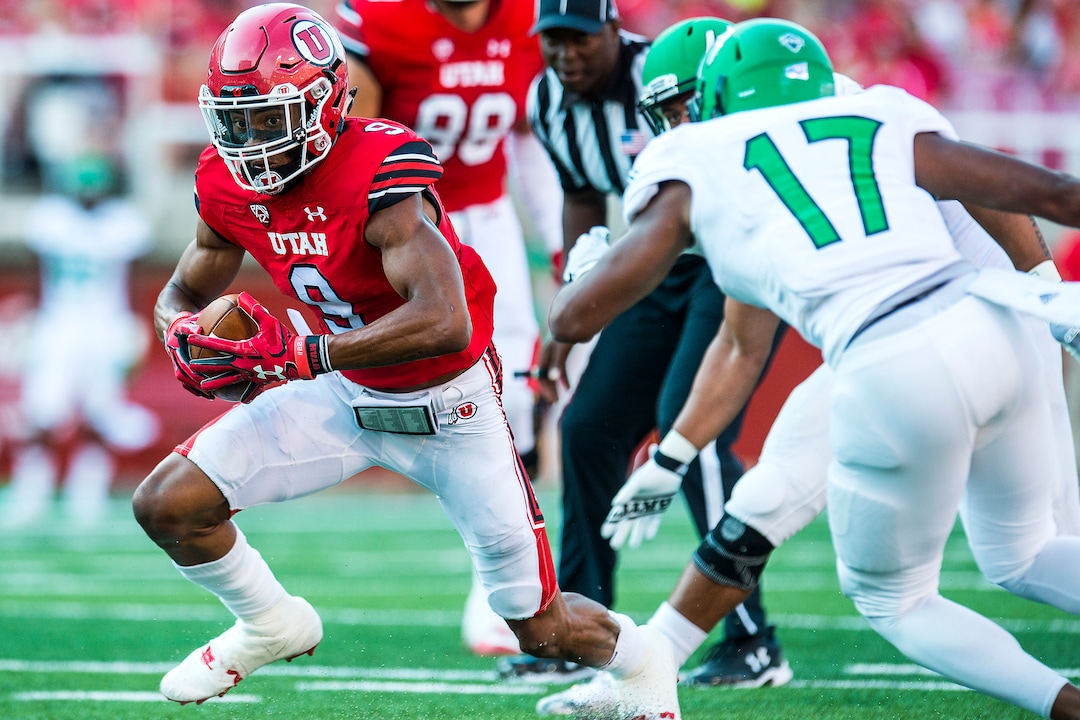 (Chris Detrick  |  The Salt Lake Tribune)  Utah Utes wide receiver Darren Carrington (9) runs the ball past North Dakota Fighting Hawks defensive back Chuck Flowers (17) during the game at Rice-Eccles Stadium Thursday, August 31, 2017. Utah Utes are leading North Dakota Fighting Hawks 17-9 at halftime. 