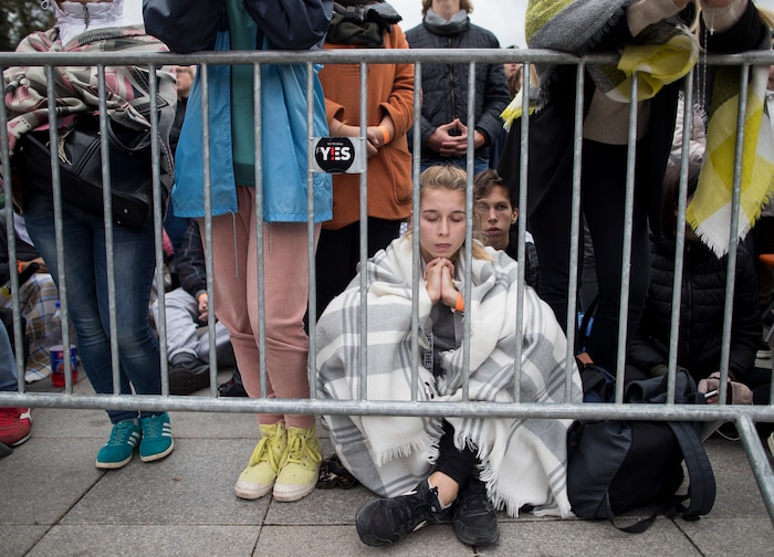 (Mindaugas Kulbis  |  AP Photo)  A girl prays as faithful gather in Cathedral Square as they wait for the arrival of Pope Francis, in Vilnius, Lithuania, Saturday Sept. 22, 2018. Pope Francis begins a four-day visit to the Baltics amid renewed alarm about Moscow's intentions in the region it has twice occupied.