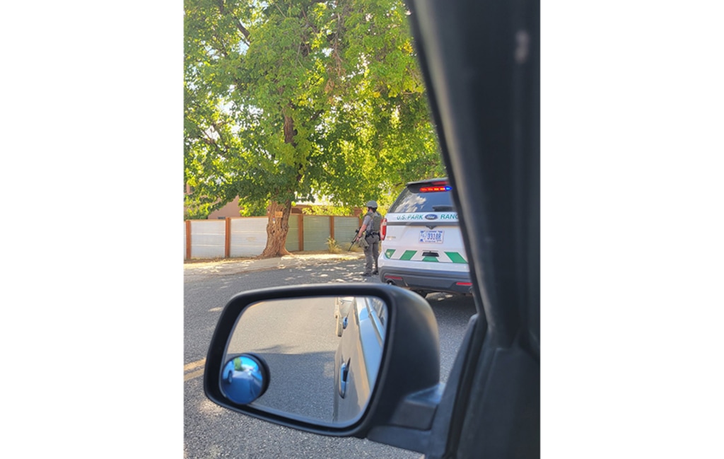 (Jayson Jessop) An officer stands near a police perimeter established on state Route 9 near Rockville during an "active shooter" situation on Wednesday, October 6, 2021.
