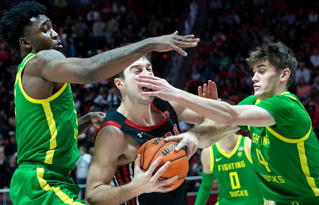 (Leah Hogsten | The Salt Lake Tribune) Utah Utes guard Lazar Stefanovic (20) is stopped by Oregon Ducks guard Jermaine Couisnard (5) and Oregon Ducks guard Brennan Rigsby (4) as the University of Utah hosts Oregon at the Huntsman Center, Jan. 7, 2023.