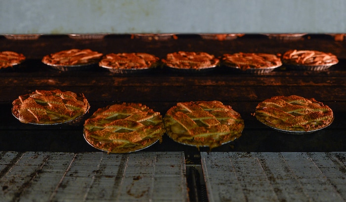 Francisco Kjolseth | The Salt Lake Tribune
Hand laid lattice apple pies roll out of the oven at Rocky Mountain Pie factory in Salt Lake recently. Eight different pies sold through Associated Food Stores earned blue ribbons in the commercial categories at the National Pie Championships.