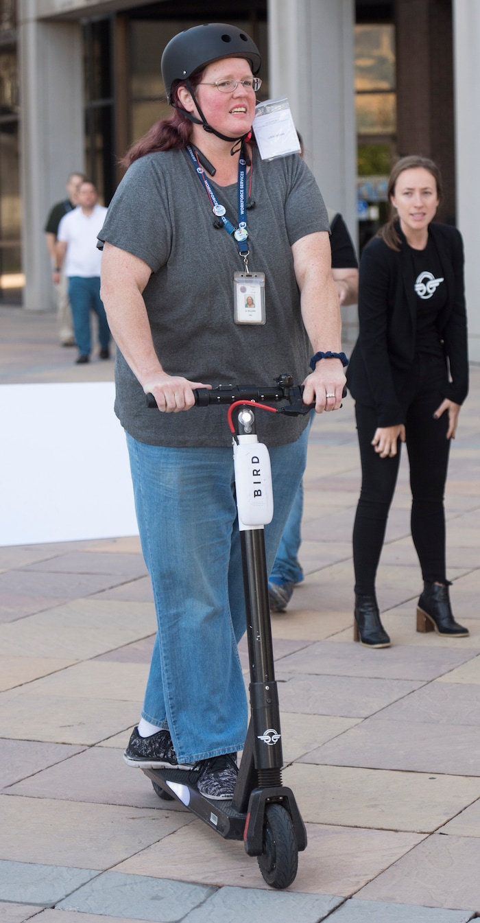 (Rick Egan  |  The Salt Lake Tribune)      Jo Killian takes a ride on the newest version of the Bird scooter, as Salt Lake City launches a new campaign with e-scooter companies Lime and Bird in an effort to help residents and visitors understand the rules of the sidewalk, Wednesday, Oct. 3, 2018.


