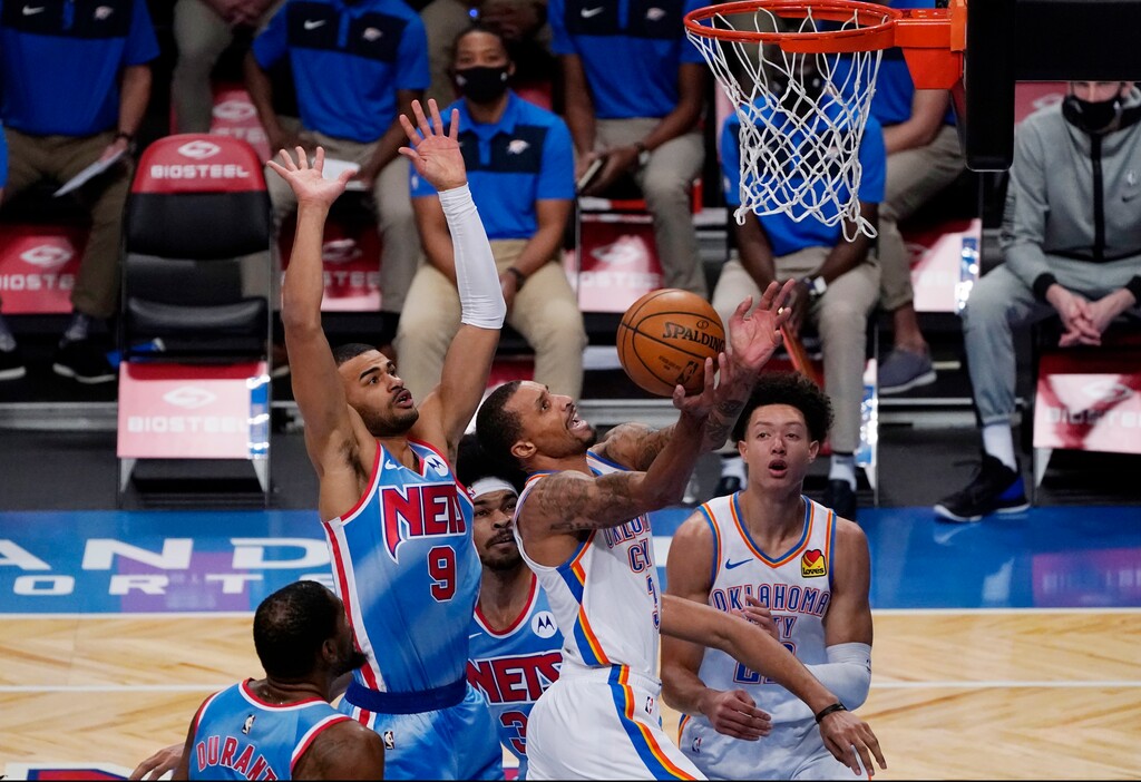 (AP Photo/Kathy Willens) | Brooklyn Nets guard Timothe Luwawu-Cabarrot (9) and center Jarrett Allen defend against Oklahoma City Thunder guard George Hill (3) as Hill goes up for a layup during the first quarter of an NBA basketball game Sunday, Jan. 10, 2021, in New York. Hill, a Utah Jazz alum, is an outspoken critic of the new COVID-19 restrictions the NBA handed down this week.
