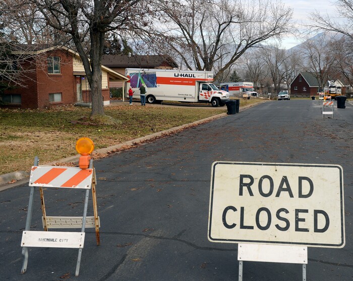 (Al Hartmann | The Salt Lake Tribune)
Four houses near the edge of a canyon slope near 4860S. 600 W. in Riverdale have been evacuated due to a landslide in their backyard. U Haul trucks in the front yards are ready to move household belongings.