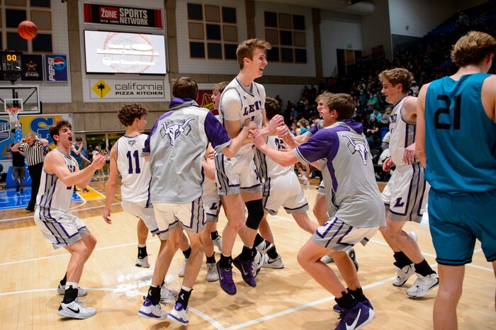 (Trent Nelson | The Salt Lake Tribune) Lehi players celebrate a win over Farmington High School in the 5A boys basketball state championship game, in Taylorsville on Saturday, March 6, 2021.